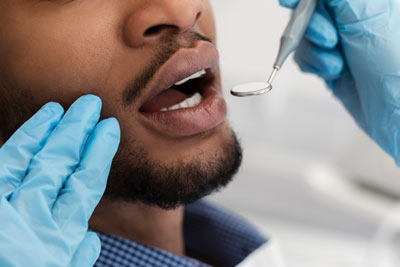 man receiving a dental checkup in Havertown, PA