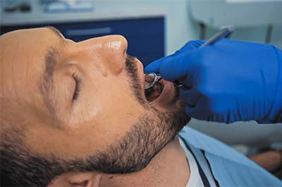 man undergoing a dental procedure due to sedation dentistry